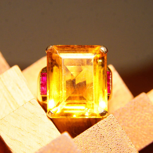 14K yellow gold cocktail ring featuring a large emerald-cut citrine gemstone accented by two ruby side stones, estate jewelry, ring size 6 3/4 US.