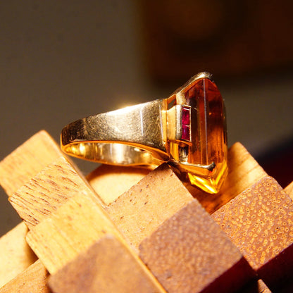 14K yellow gold cocktail ring with large emerald-cut citrine center stone flanked by rectangular ruby accents, estate jewelry piece in a size 6 3/4 US.