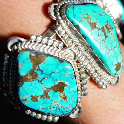 Vintage Native American turquoise cuff bracelet featuring three large turquoise stones set in chunky, ornate silver metalwork, crafted in Mexico, measuring 5 3/4 inches long.