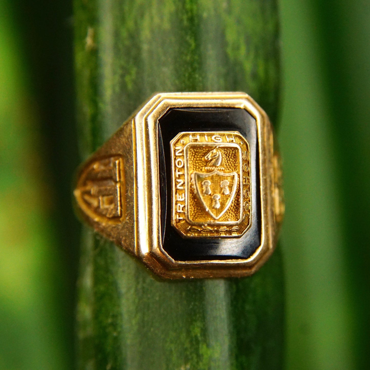 Vintage 1938 10K gold and onyx Trenton High School class ring with engraved crest, size 6 3/4 US, photographed on green background