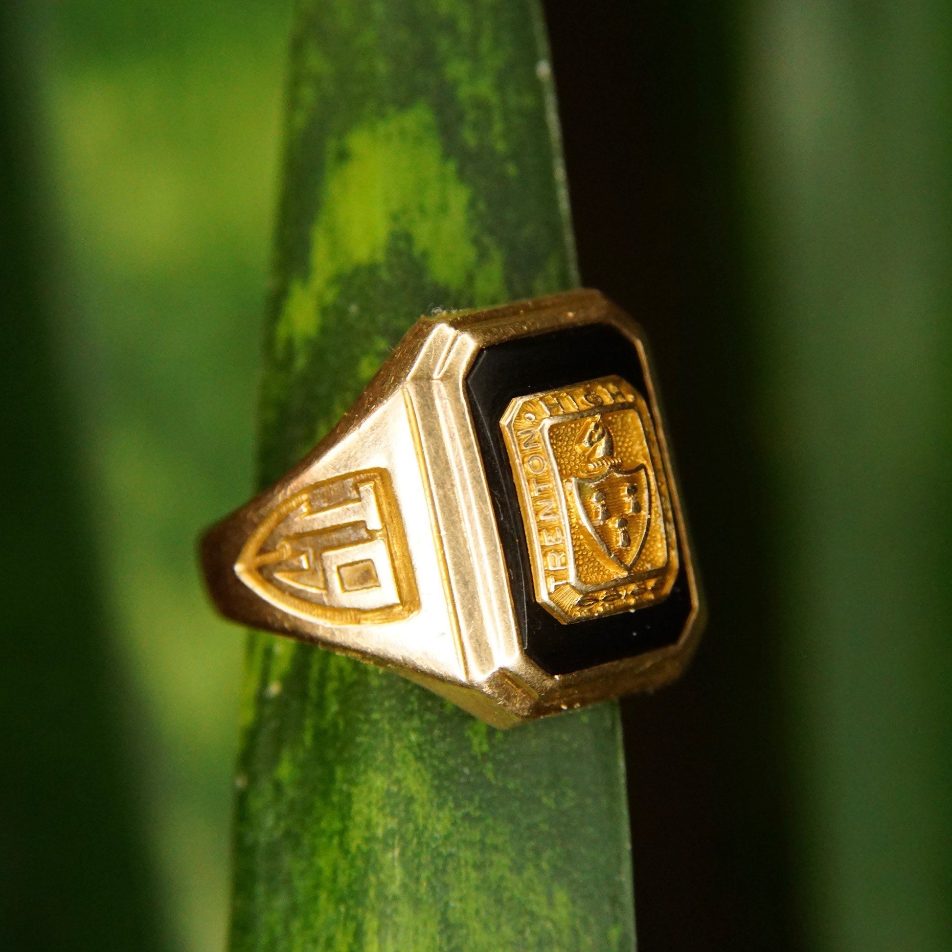 Vintage 1938 10K yellow gold and black onyx Trenton High School class ring with engraved details, size 6 3/4 US, resting on a green background