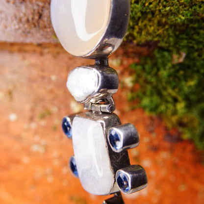 Vintage sterling silver hinged pendant with moonstone, mother of pearl, quartz and purple/blue gemstones, measuring 3 1/8 inches long, showcasing an abstract modernist design.