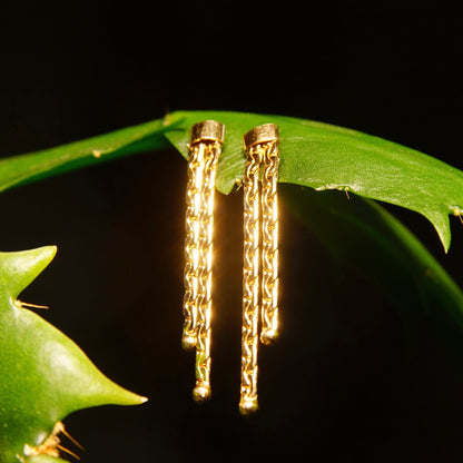 Vintage 14K gold chain tassel dangle earrings with push backs against green leaves, featuring two strands of half anchor links, measuring approximately 1 3/8 inches in length.