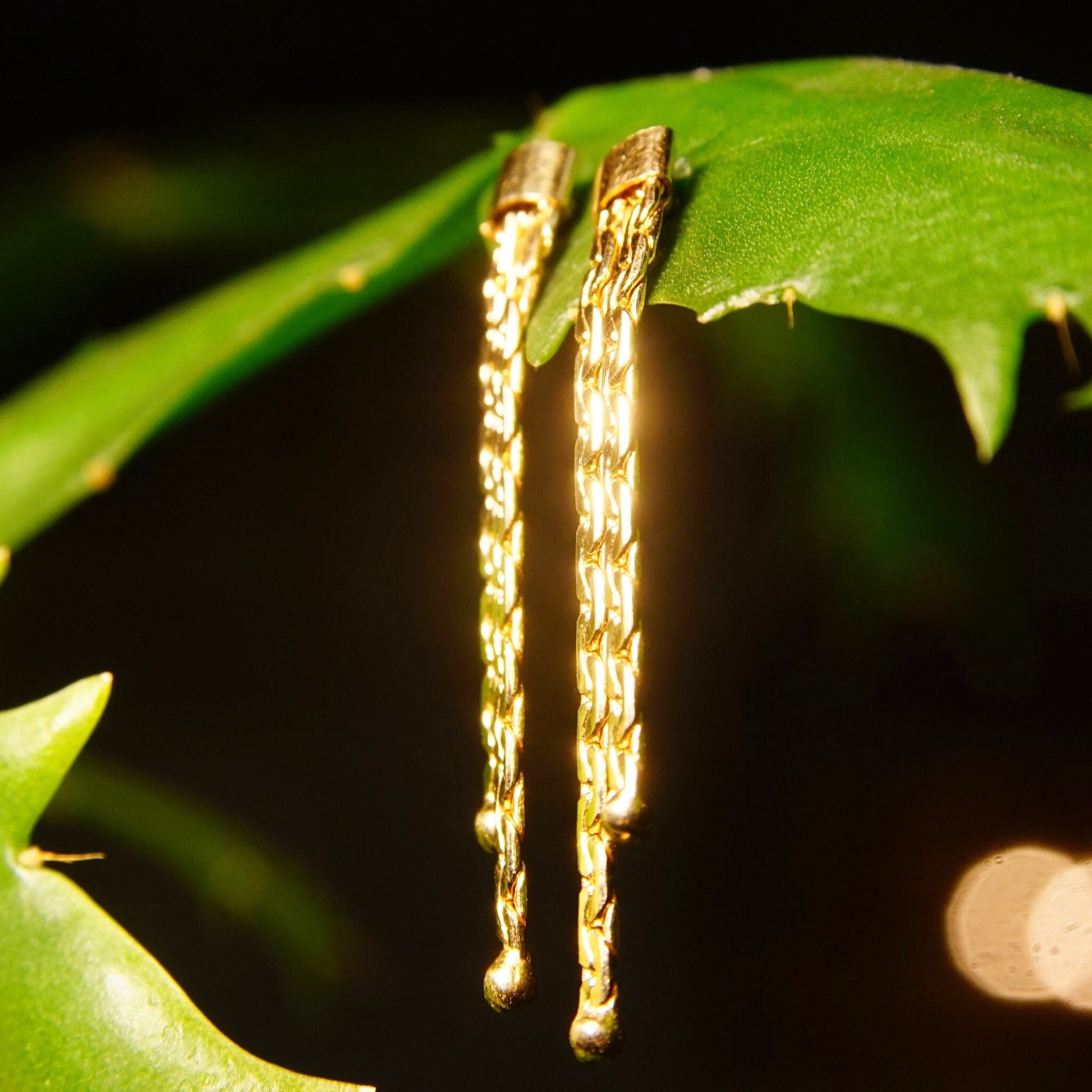 Vintage 14K gold chain tassel earrings with push backs, featuring two delicate strands of half anchor links dangling from green leaf, approximately 1 3/8 inches long.