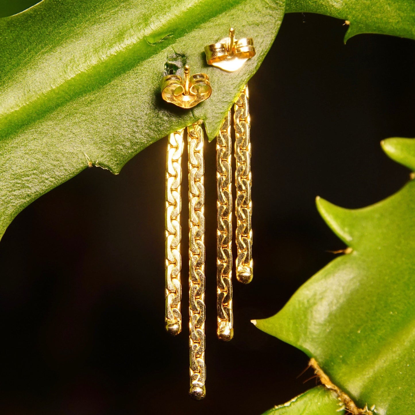 Vintage 14K gold tassel dangle earrings with virola chain and half anchor links, featuring 2 strands and push back closures, measuring 1 3/8 inches long.