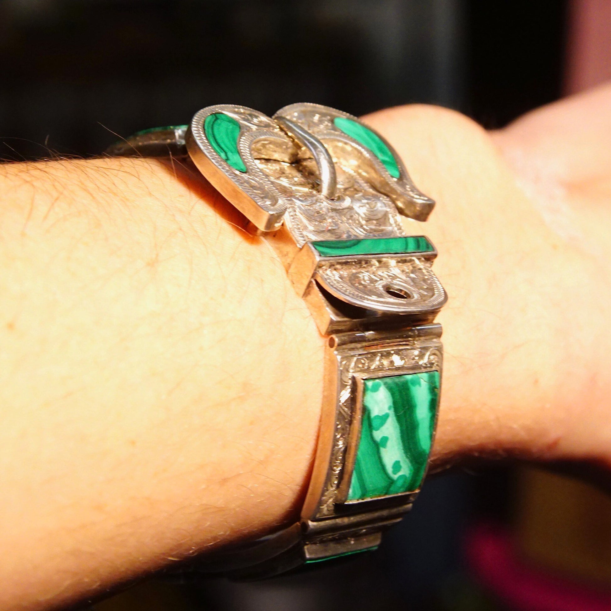 Antique Victorian silver bracelet with malachite inlay and ornate etched designs on the buckle-shaped links, measuring 7 1/8 inches long.