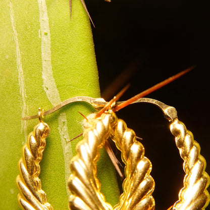 Vintage 14K yellow gold scalloped hoop earrings with intricate twisted rope design, crafted in Italy, measuring approximately 1 1/4 inches in length.