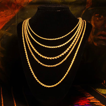 Vintage 14K yellow gold rope chain necklaces displayed on black velvet, an elegant unisex jewelry piece with classic hollow gold rope design in various lengths from 16 to 24 inches, 585 gold purity.