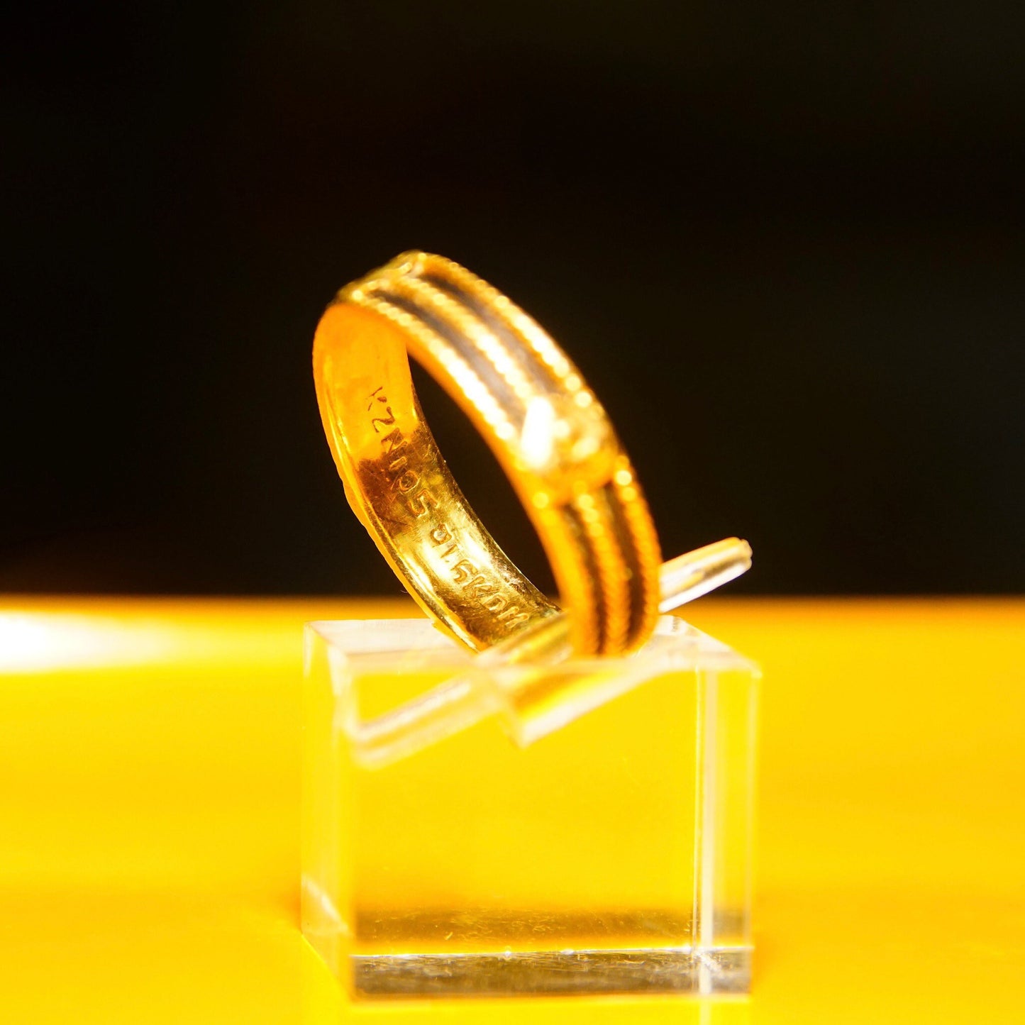 Vintage 22K yellow gold wedding band with black inlay and heart embellishments on yellow background, 5mm wide band, Indian handmade jewelry in size 8 US.