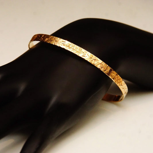 14K yellow gold floral bangle bracelet with diamond-cut designs, 5mm wide, perfect for stacking or wearing alone