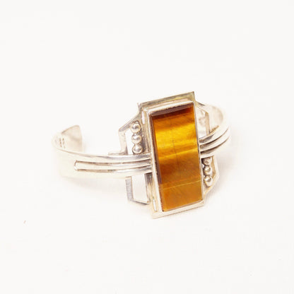 Vintage TAXCO sterling silver cuff bracelet featuring a polished rectangular tigers eye gemstone, with engraved Mexico 925 hallmark. Modernist design, measuring 5 1/8 inches in length.