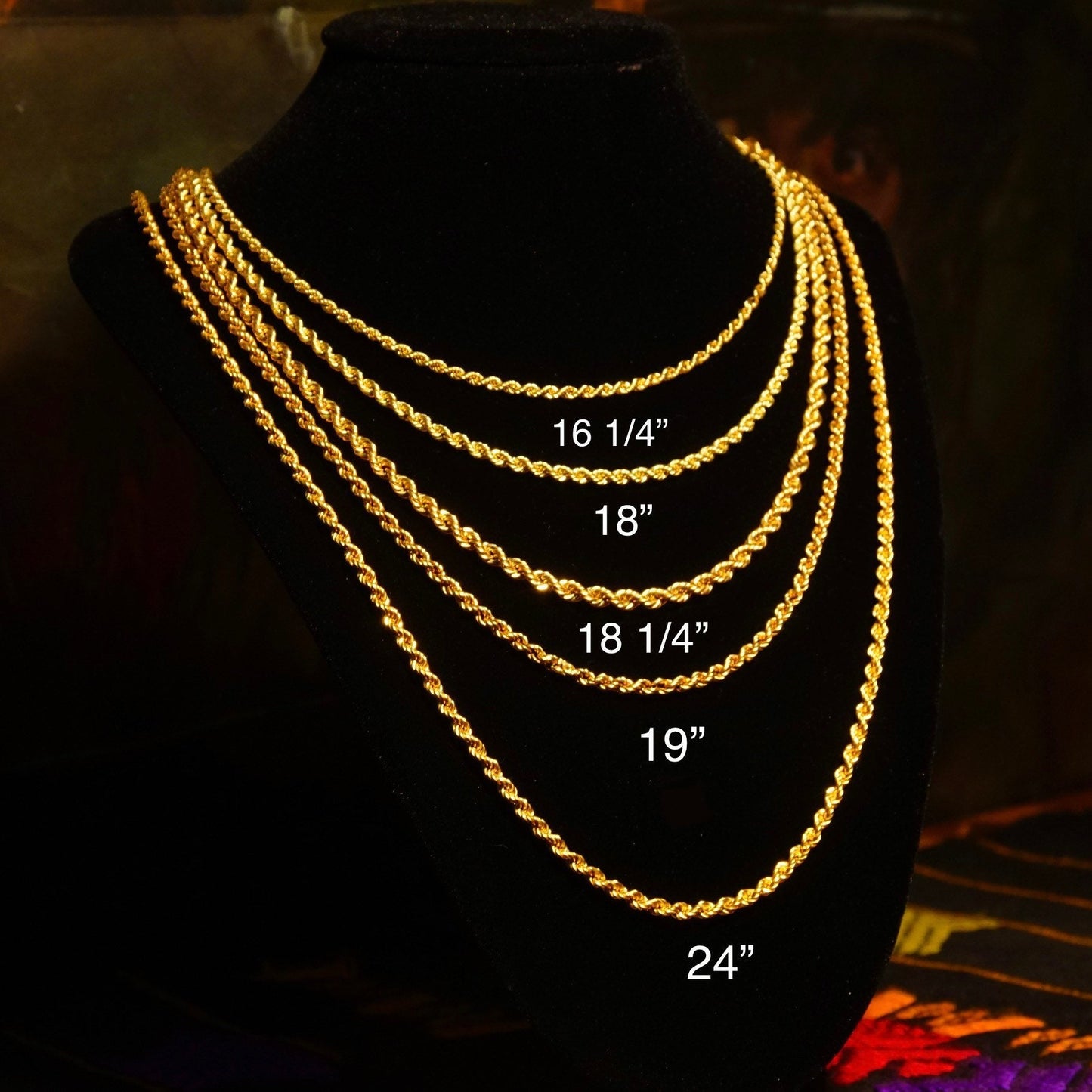 Vintage 14K yellow gold hollow rope chain necklaces in varying lengths from 16 to 24 inches displayed on black velvet jewelry display bust.