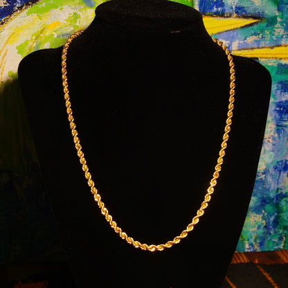 Vintage 14K yellow gold hollow rope chain necklace displayed on black velvet with colorful abstract painting in background, unisex classic gold chain jewelry in 16-24 inch lengths, 585 gold