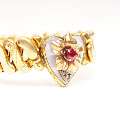 Antique Victorian gold-filled heart stretch bracelet featuring shell inlay, a faux ruby accent, floral embellishments, and an S-link stretch band measuring approximately 5 inches in length.