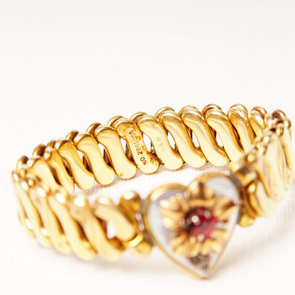 Antique Victorian gold-filled heart stretch bracelet with diamond accent, shell inlay, faux ruby, floral embellishment, and S-link stretch band measuring 5 inches long.