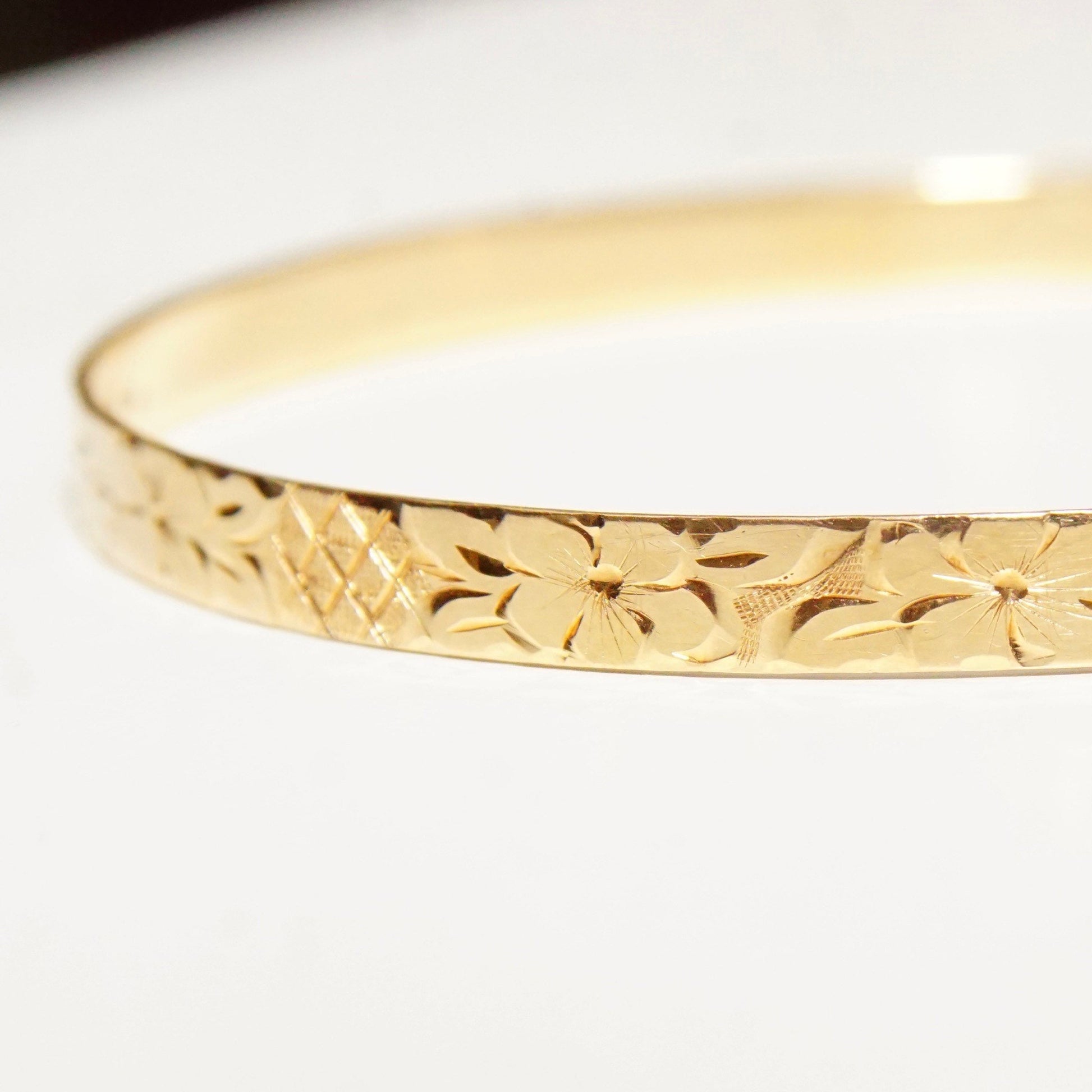 14K solid yellow gold bangle bracelet with diamond-cut floral motif designs, 5mm wide, ideal for stacking