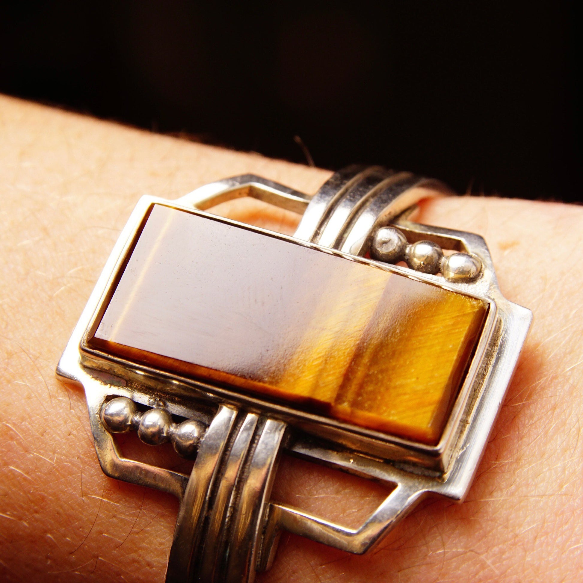 Vintage TAXCO Sterling Silver Tigers Eye Cuff Bracelet with a polished rectangular gemstone, engraved with "Mexico 925", measuring 5 1/8 inches long in a modernist style.