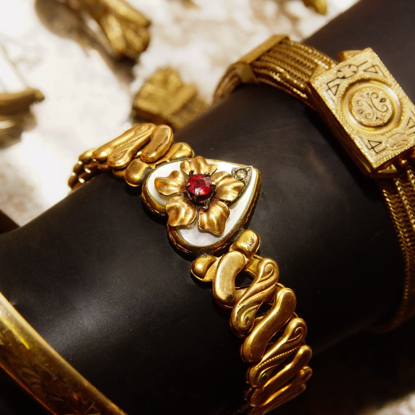 Antique Victorian gold-filled heart stretch bracelet with diamond accent, shell inlay, faux ruby, floral embellishment, and S-link stretch band, measuring 5 inches long.