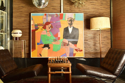 Colorful modernist painting depicting a stylized man and woman in bright, blocky shapes against an orange background, tempura on masonite, 1976 original artwork by Richard Merkin titled "The Poet Of Wickedness #2", measuring 42 inches by 50 inches, displayed in a living room with leather chairs and lamp.