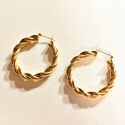 Gold twist hoop earrings, 14K yellow gold spiral hoops, chunky vintage statement earrings, 40mm diameter, on white fabric background