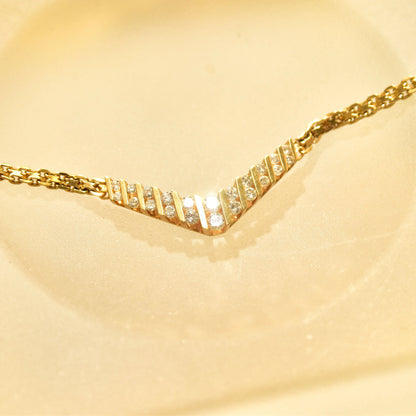 14K yellow gold chevron necklace with channel set round brilliant cut diamonds on a thin mesh link chain, 15 1/4 inches long