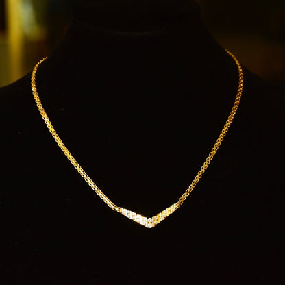 14K yellow gold chevron necklace with channel set brilliant cut diamonds on a delicate mesh link chain, 15 1/4 inches in length.