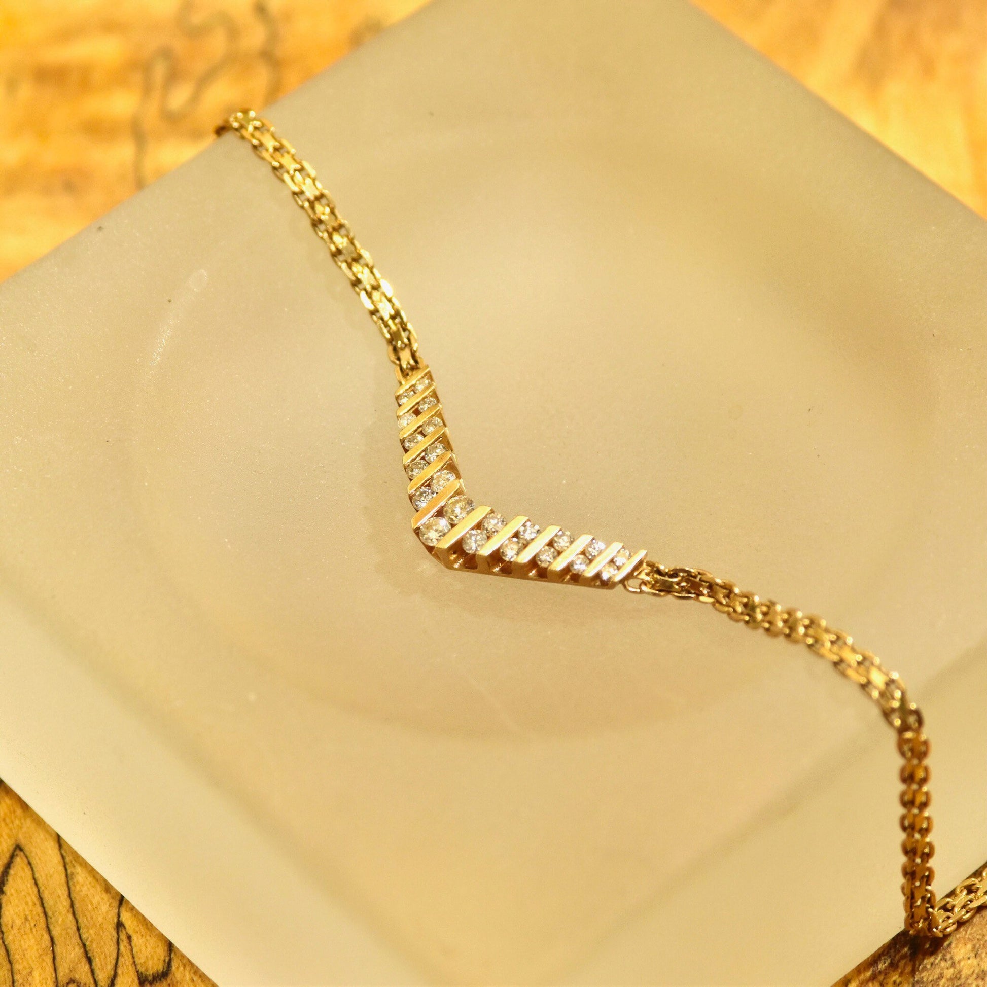 14K yellow gold diamond chevron necklace with channel set brilliant diamonds on a delicate mesh link chain, 15 1/4 inches long.