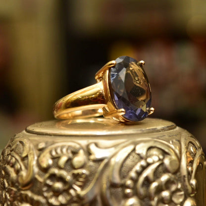 Vintage gold-plated sterling silver ring with oval-cut blue gemstone, ornate engraved details on the band, size 7 US.