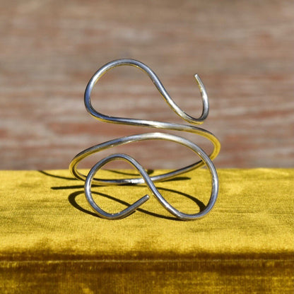 Vintage solid sterling silver wire wrap cuff bracelet featuring minimalist swirl design. Bohemian style 925 silver adjustable bracelet, 7 1/2 inches.