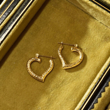 Vintage 14K yellow gold hammered textured heart hoop earrings, 22mm size, on antique gold background