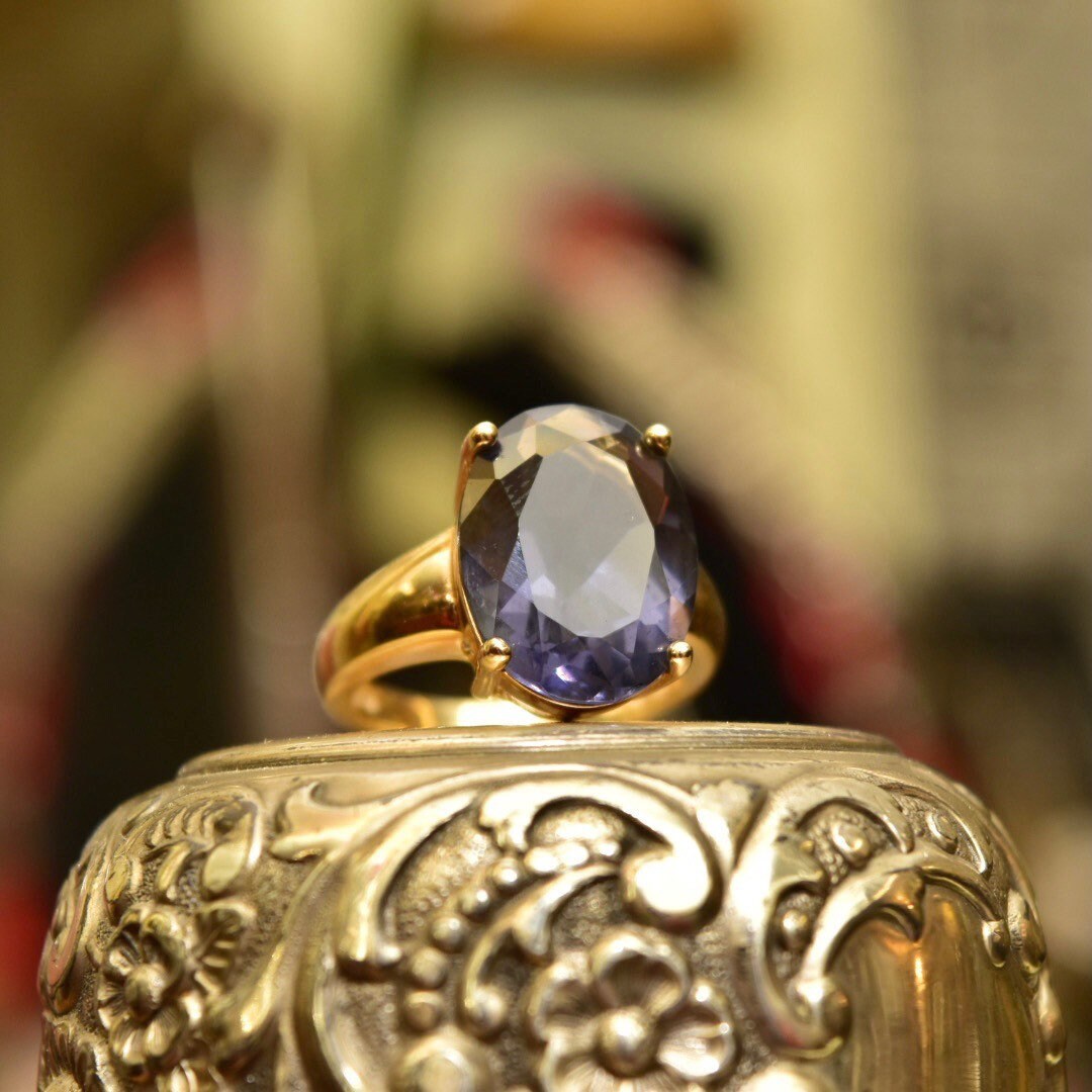 Vintage gold-plated sterling silver cocktail ring with oval-cut simulated blue gemstone, ornate filigree design, size 7 US.