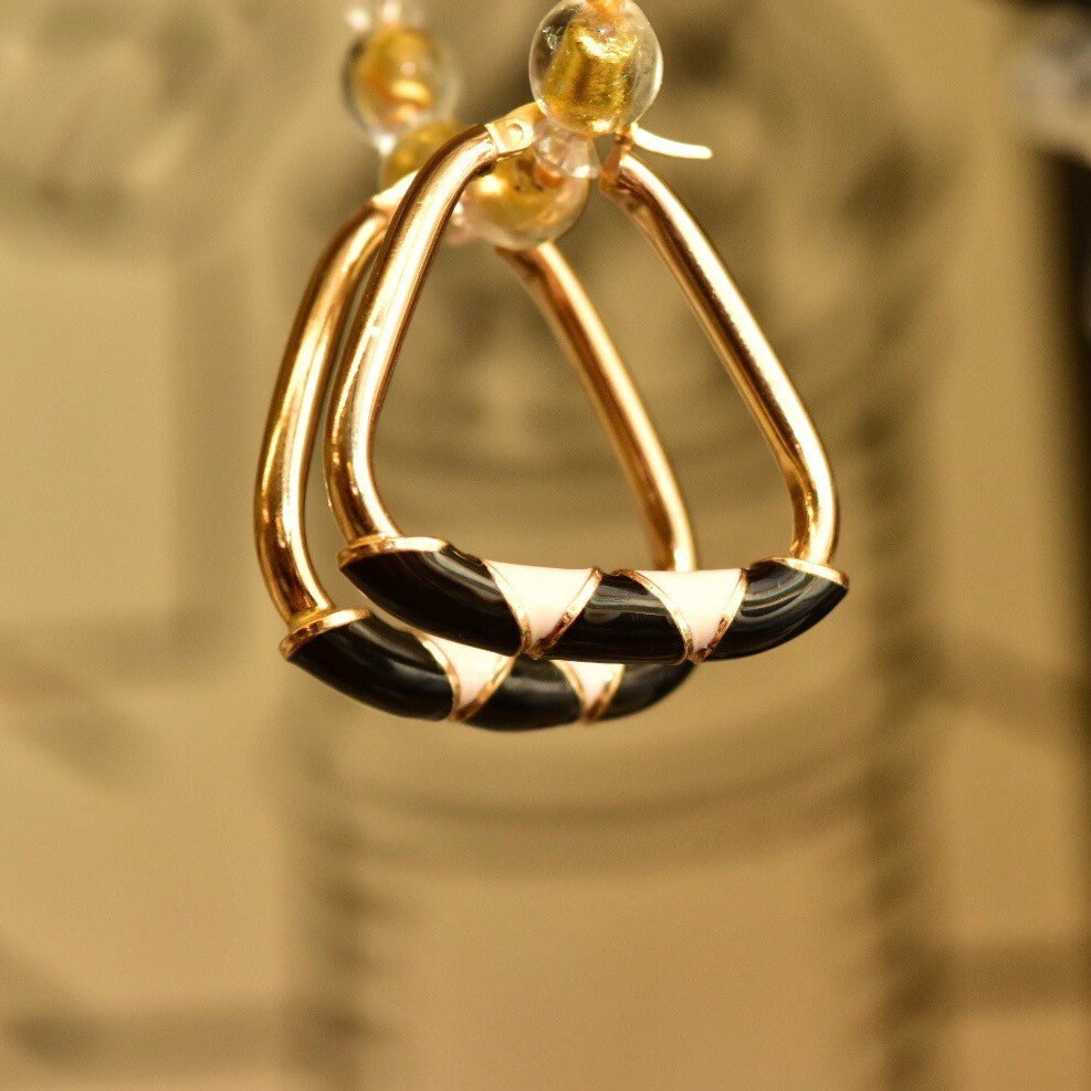 14K gold hoop earrings with black and beige enamel triangular designs, modernist statement earrings measuring 35mm in diameter.