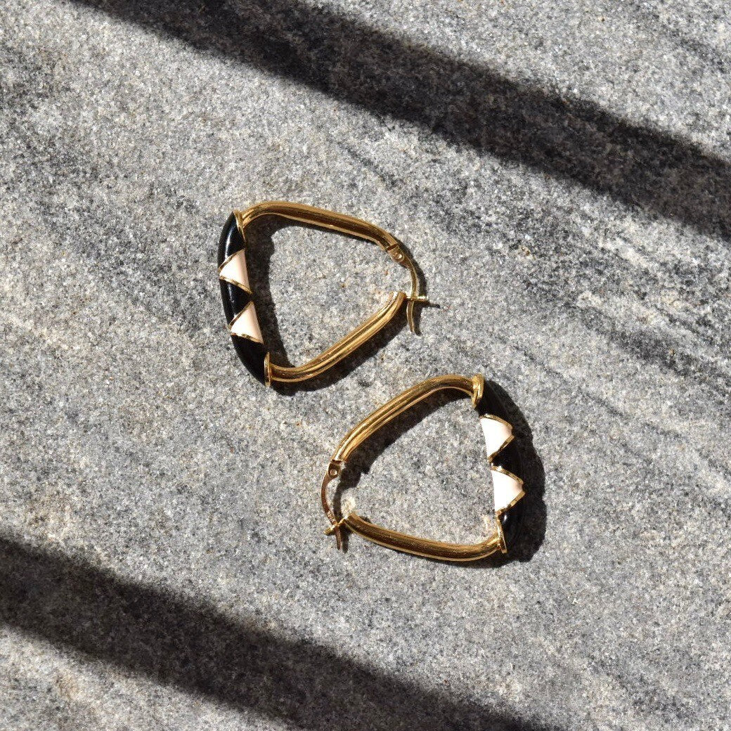 14K gold triangular hoop earrings with black and beige enamel designs, 35mm statement earrings, shown on gray textured background