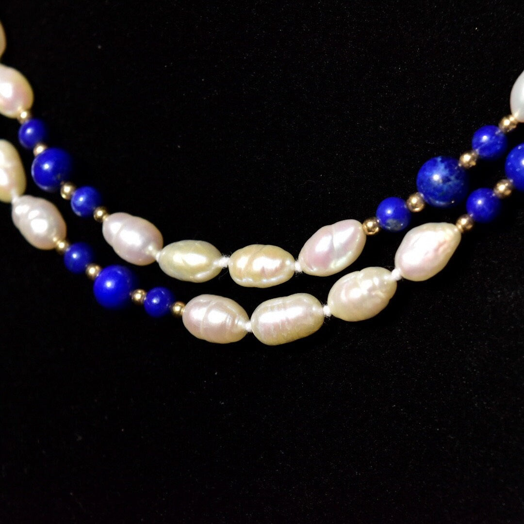 Vintage 14K gold necklace with knotted fresh water baroque pearls and polished lapis lazuli beads, accented by gold beads, measuring 29 inches in length.