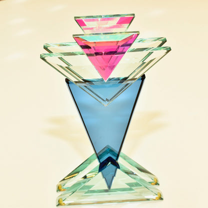 Vintage 1989 signed American studio art glass sculpture by Stephen Jon Clements. Opulent modernist geometric pyramid design in shades of blue, teal, pink and clear glass. Measures 10 1/8 inches tall.