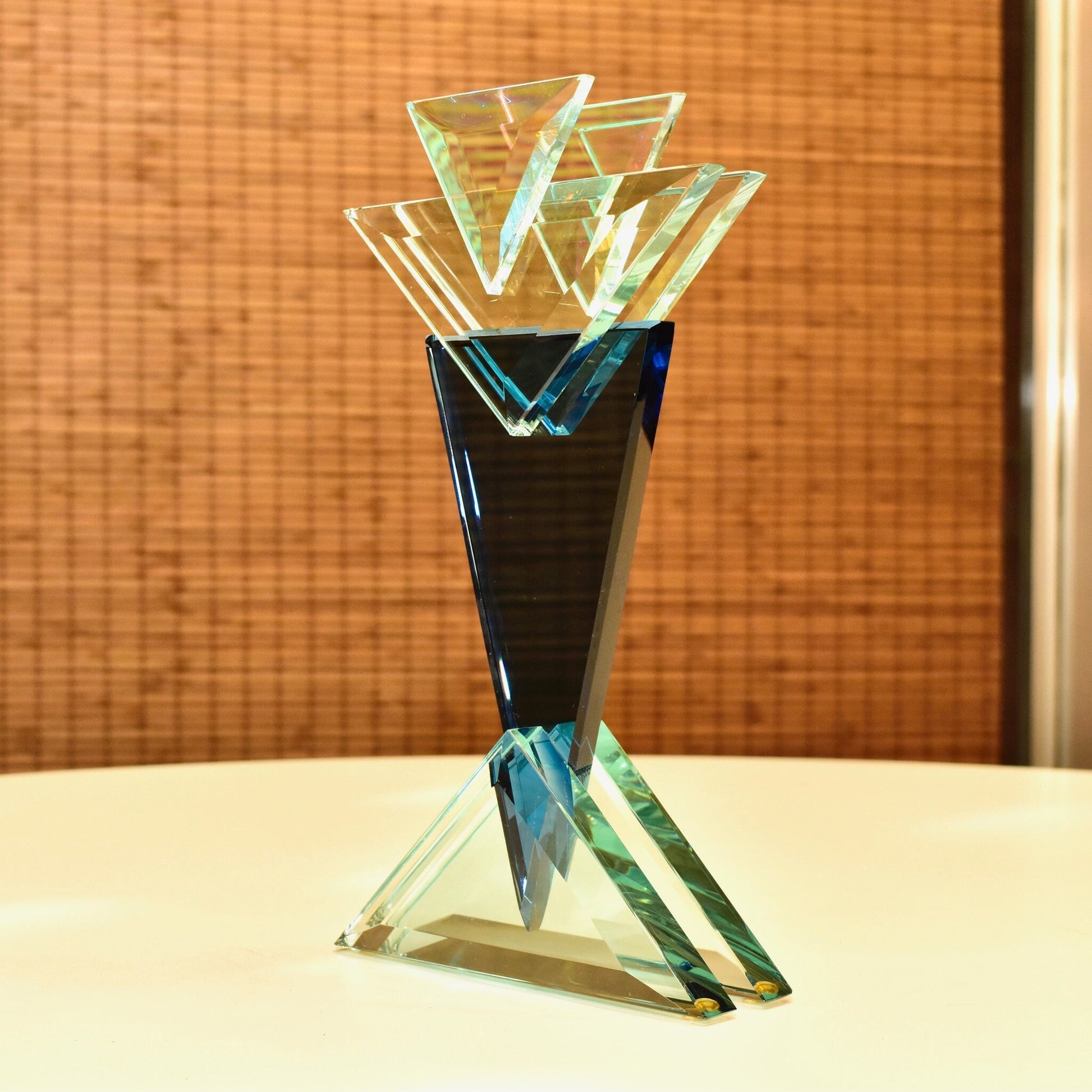 Vintage 1989 signed American studio art glass abstract geometric sculpture by Stephen Jon Clements. The modernist glass tabletop sculpture features clear and blue angular forms rising from a triangular base, measuring 10 1/8 inches tall.