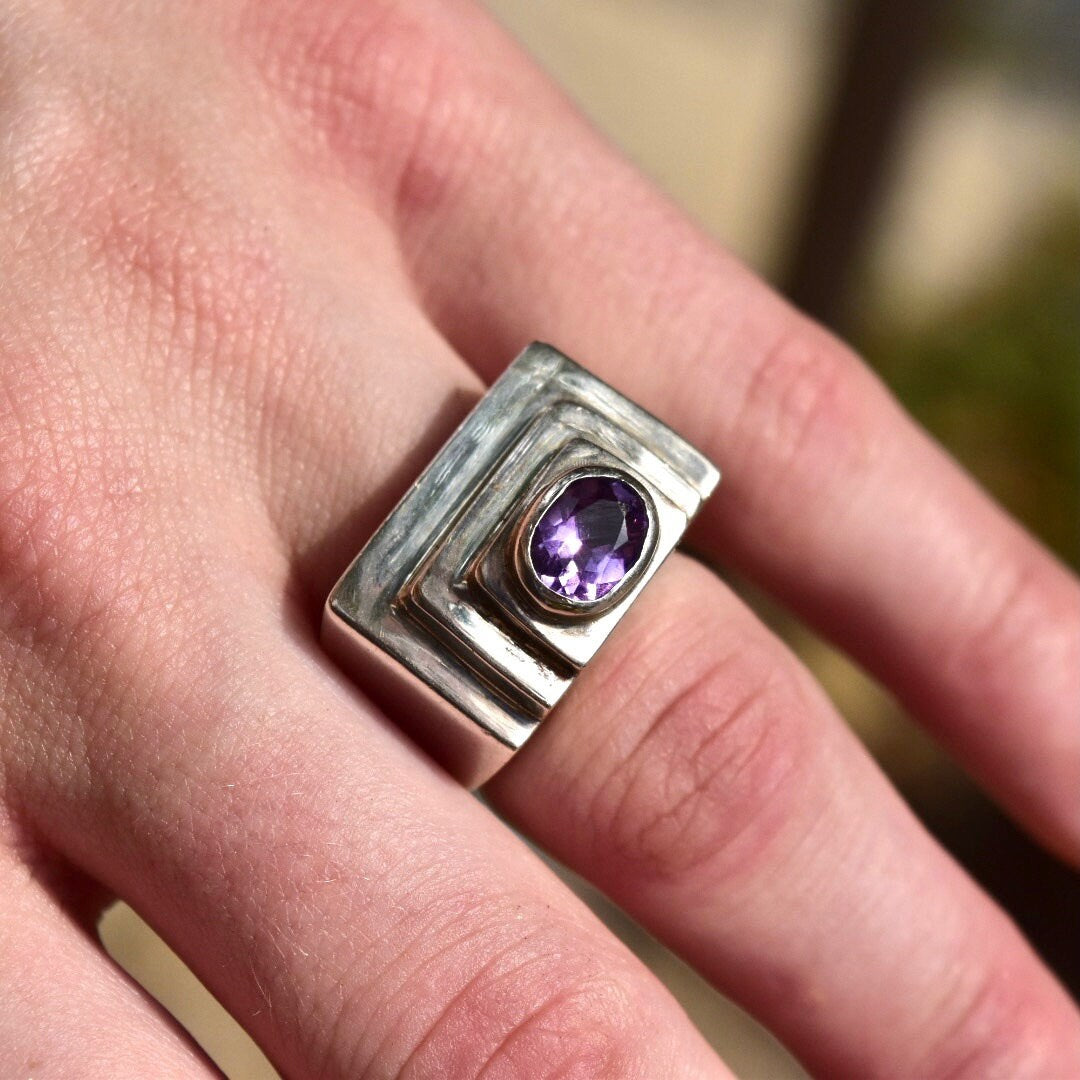 Vintage modernist sterling silver ring with oval cut amethyst gemstone set in a chunky textured dome design, size 6 1/2 US.