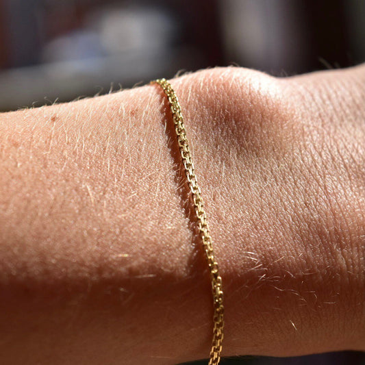 14K gold bismark chain bracelet with 2mm flat mesh links and spring-ring clasp, minimalist jewelry, 7 inches long, on human wrist