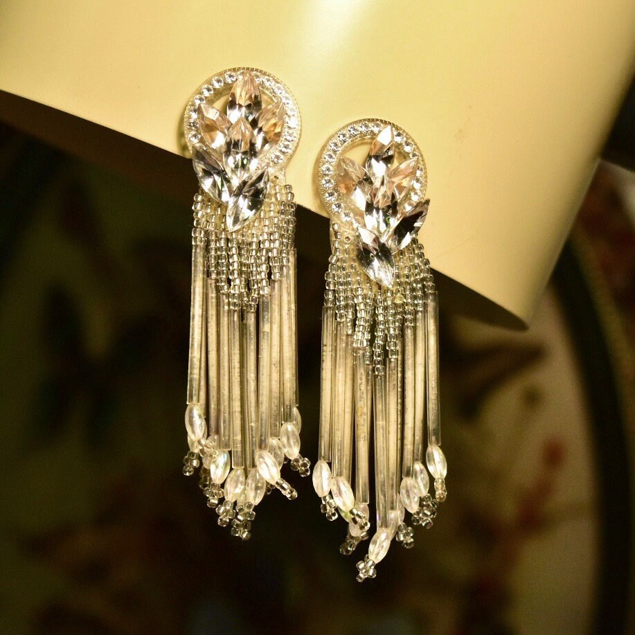 Vintage beaded chandelier clip-on earrings with ornate teardrop tassels, measuring 3 3/4 inches long, costume jewelry.