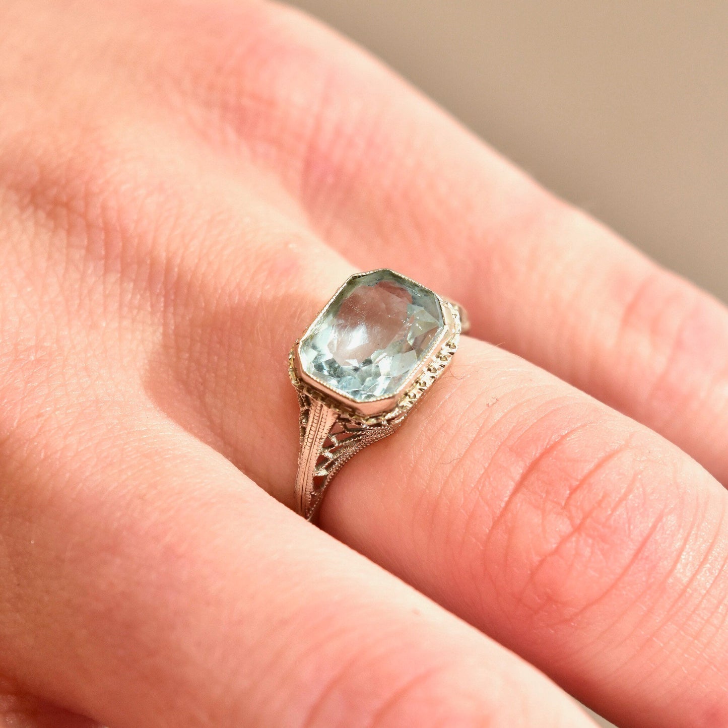 Antique Art Deco 14K white gold filigree ring with a pale blue faceted aquamarine gemstone in an intricate setting, size 6 1/2 US, perfect as a March birthstone ring.