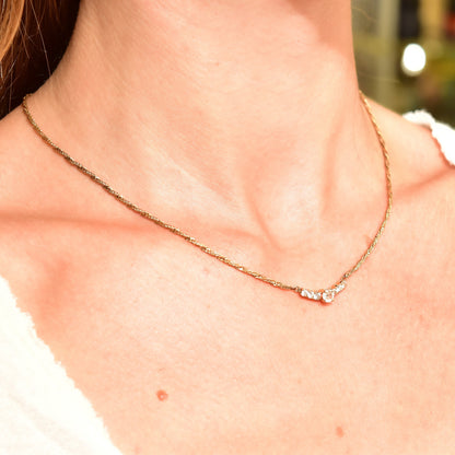 14K yellow gold diamond bar necklace with shared prong setting on an elegant 2mm Singapore chain collar, 17 1/2 inches long, shown on a woman's neck.