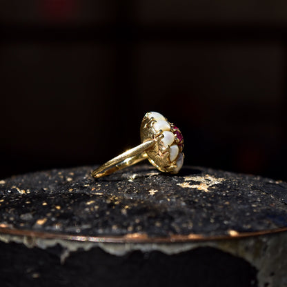 14K yellow gold pearl and ruby flower dome cluster ring, size 9 US, on dark textured surface