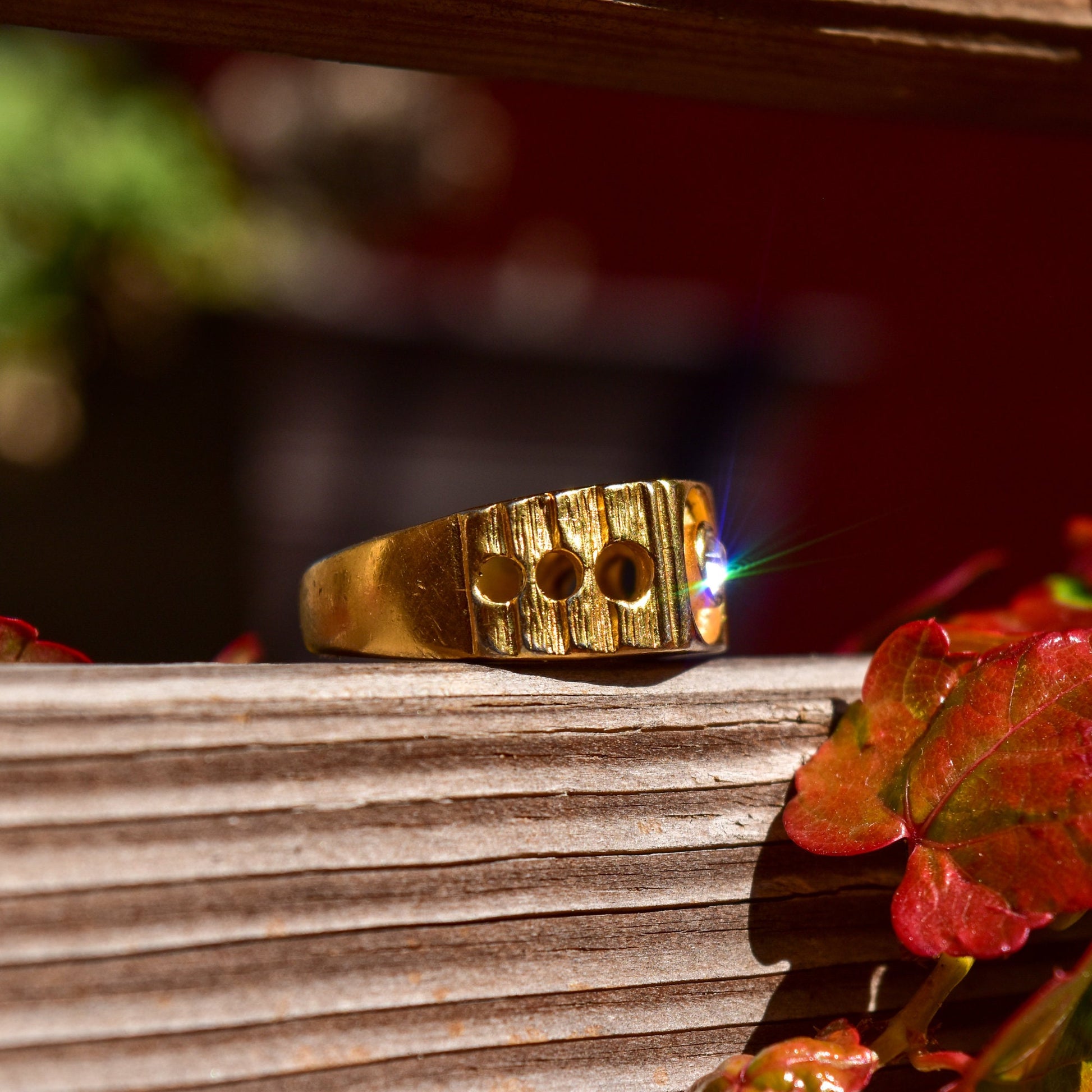 Vintage 18K gold-plated textured signet ring with circular cutouts, size 9, displayed on wooden surface with fall leaves.