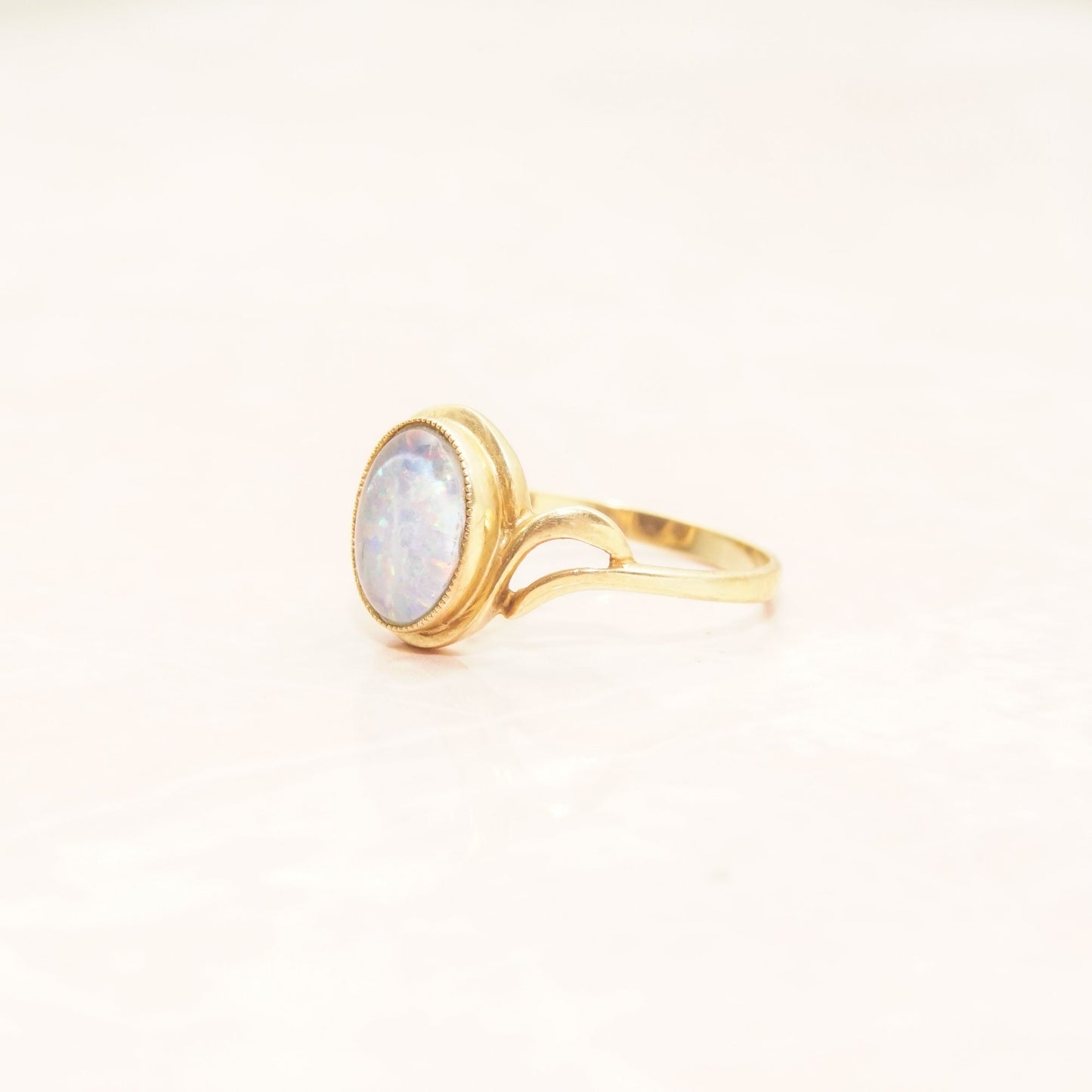 10K yellow gold cocktail ring with oval opal triplet center stone, elegant bypass design shank, estate jewelry, perfect October birthstone gift, size 8 1/4 US.