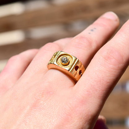 18K yellow gold modernist signet ring with diamond and circular cutout design, shown on finger, size 9 US.