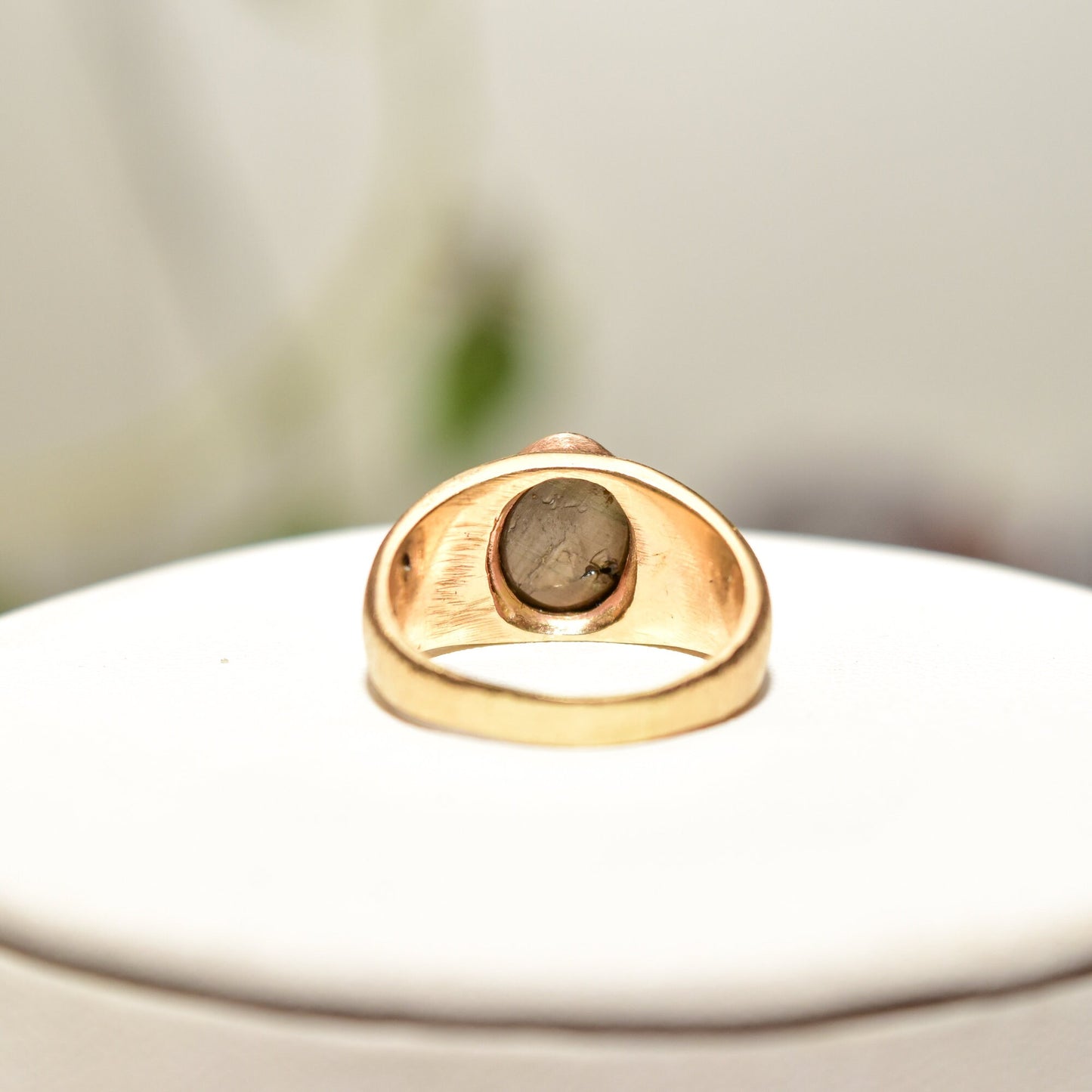 14K yellow gold men's pinky ring featuring a round black star sapphire gemstone displayed on a white background, estate jewelry piece, size 8 3/4 US.