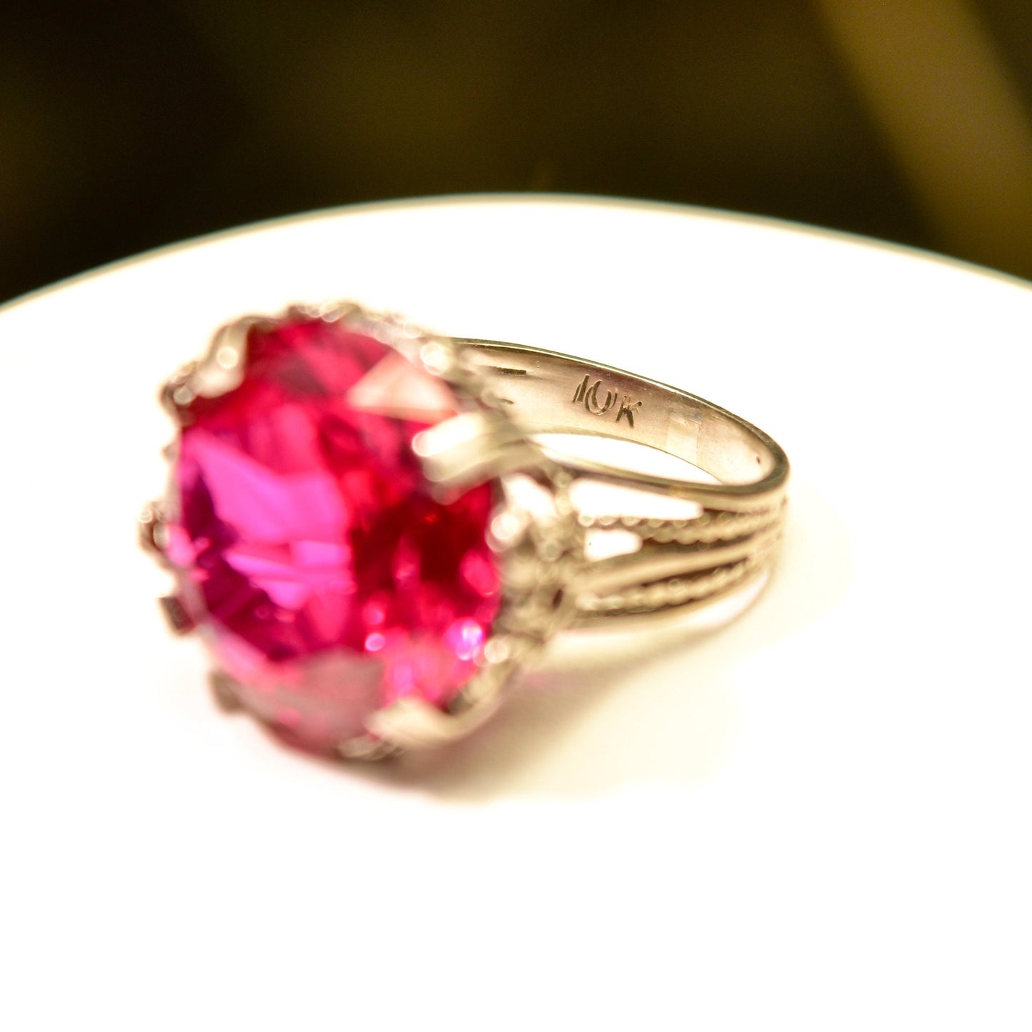 10K white gold ornate filigree cocktail ring featuring a large round synthetic pink ruby, Art Deco style, size 6 3/4 US.