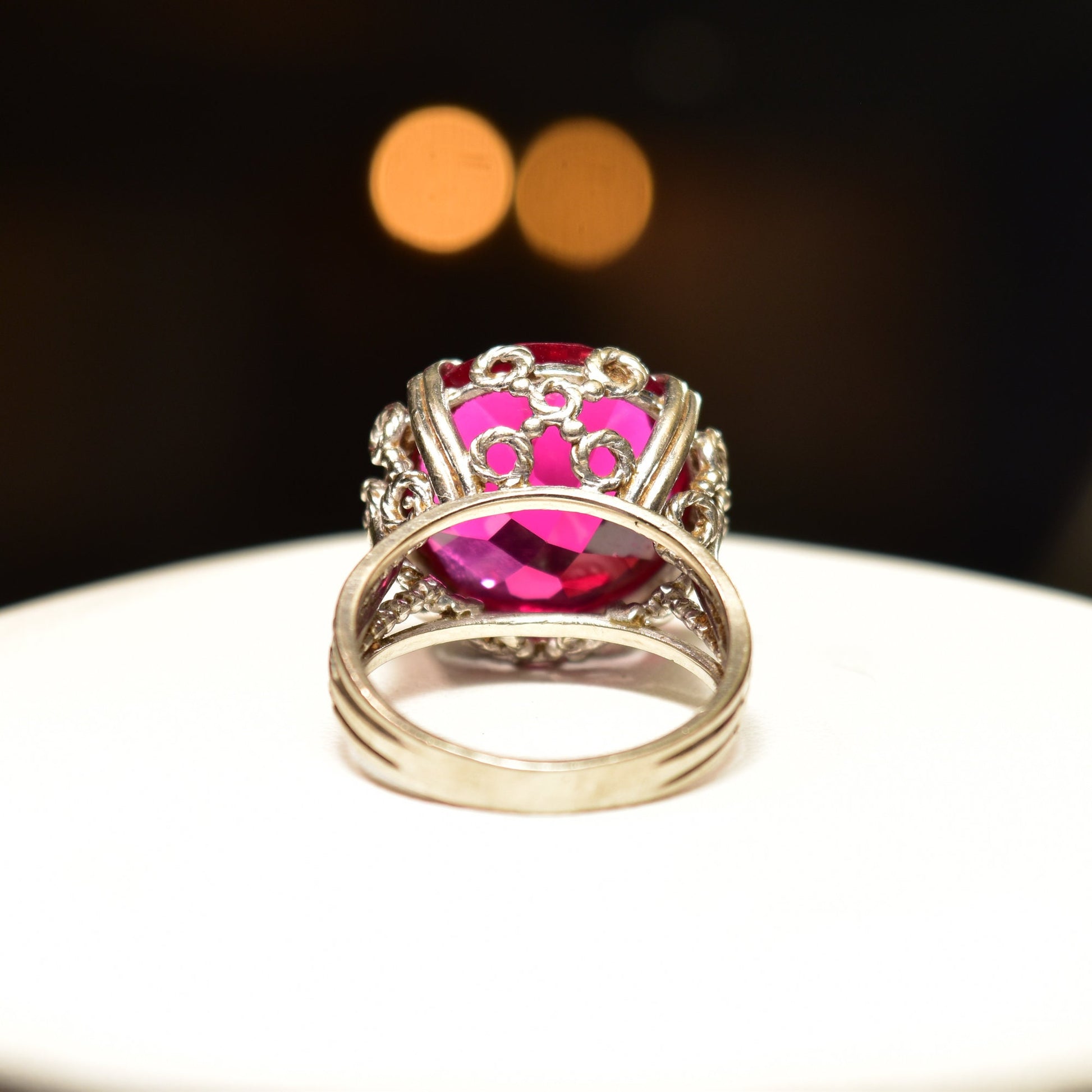 10K white gold pink ruby cocktail ring with ornate filigree setting, featuring a synthetic ruby gemstone. Art Deco style ring in a size 6 3/4 US.