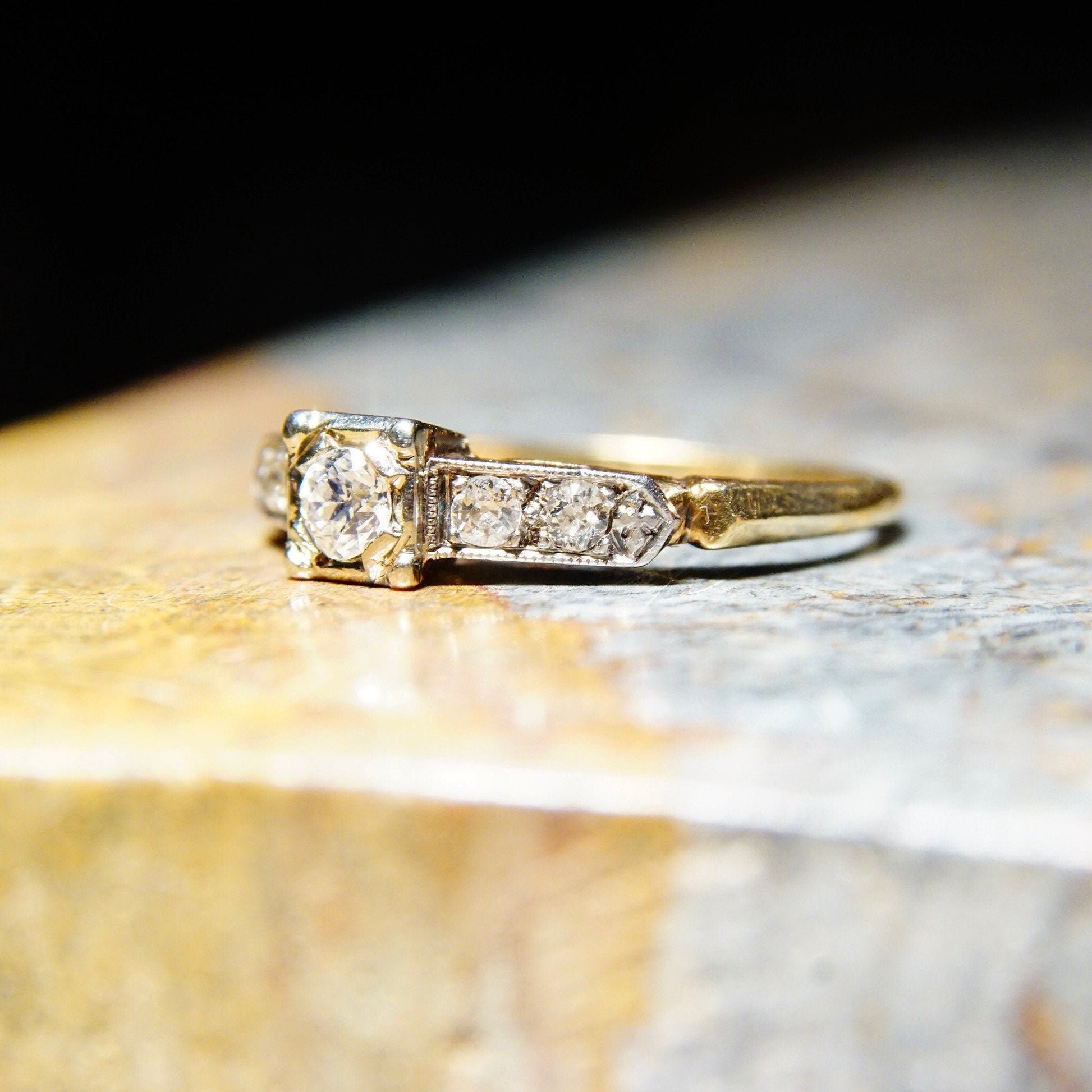 Vintage 14K and 18K gold diamond engagement ring with yellow gold band, white gold settings, and 0.14 carat old European cut center stone, size 6 1/4 US.