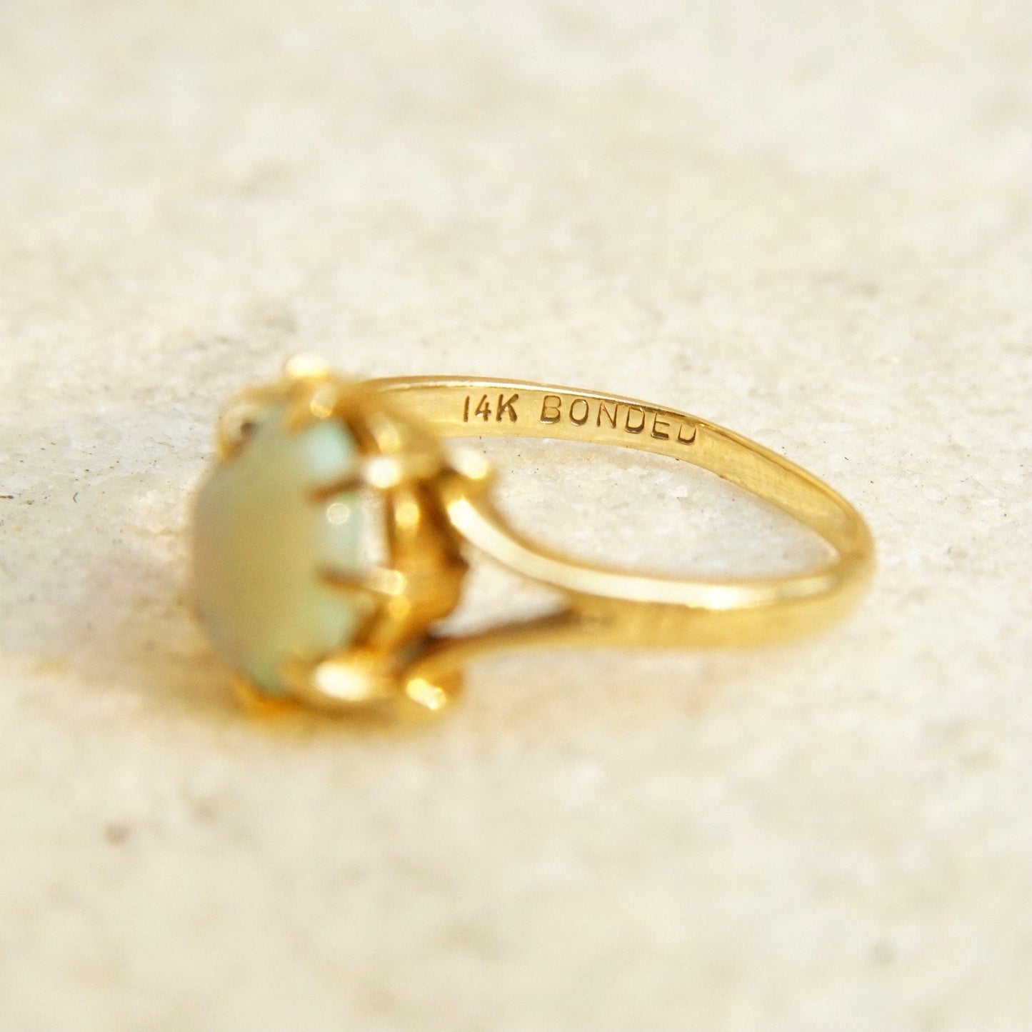 Vintage 14K bonded gold ring featuring an iridescent opal cabochon gemstone, elegant yellow gold band, 585 jewelry hallmark, ring size 4 3/4 US.